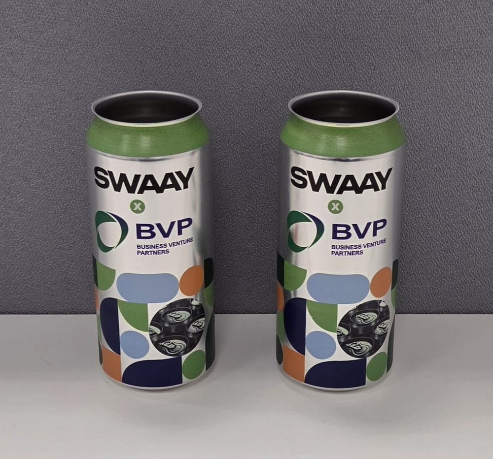 Two 440ml aluminium cans printed with Swaay x BVP Business Venture Partners branding and a multicolour geometric pattern
